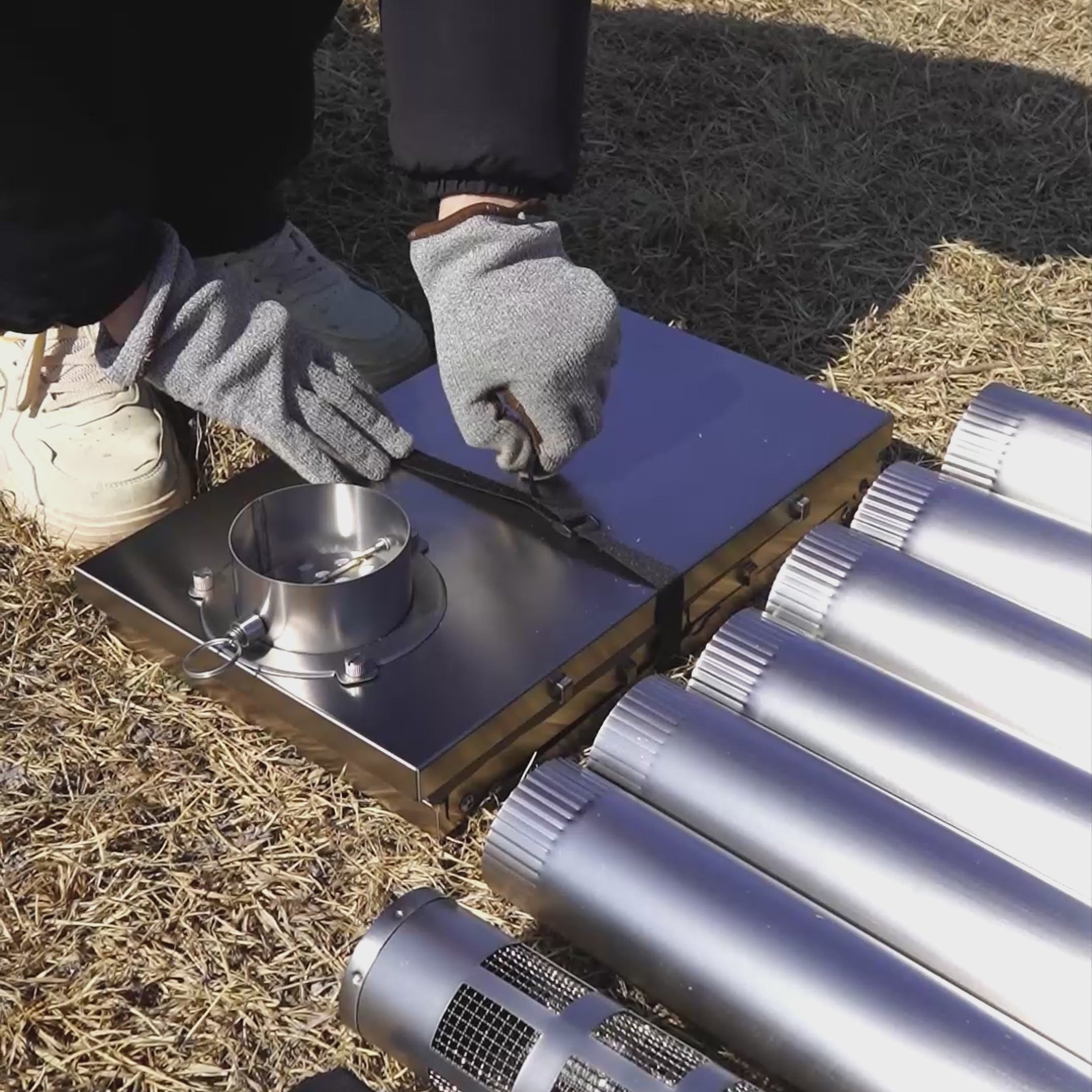 Video showcasing Winnerwell® Fastfold Titanium Camping Stove: Assembly guide with numbered chimney (easy install), dual-purpose (fire pit + cooking stove), and ground nail anchors. Watch it transform from a compact unit to a fire pit/stove, plus cooking demos—ideal for outdoor enthusiasts needing versatile, portable gear.