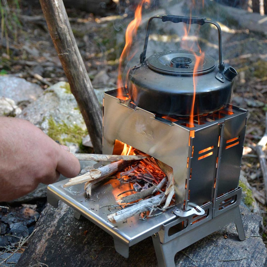 Winnerwell® Backpack Stove in action—wood - burning design cooks meals and boils water in the wilderness. Shown here with a pot and grilling setup, ideal for lightweight, off - grid outdoor cooking.
